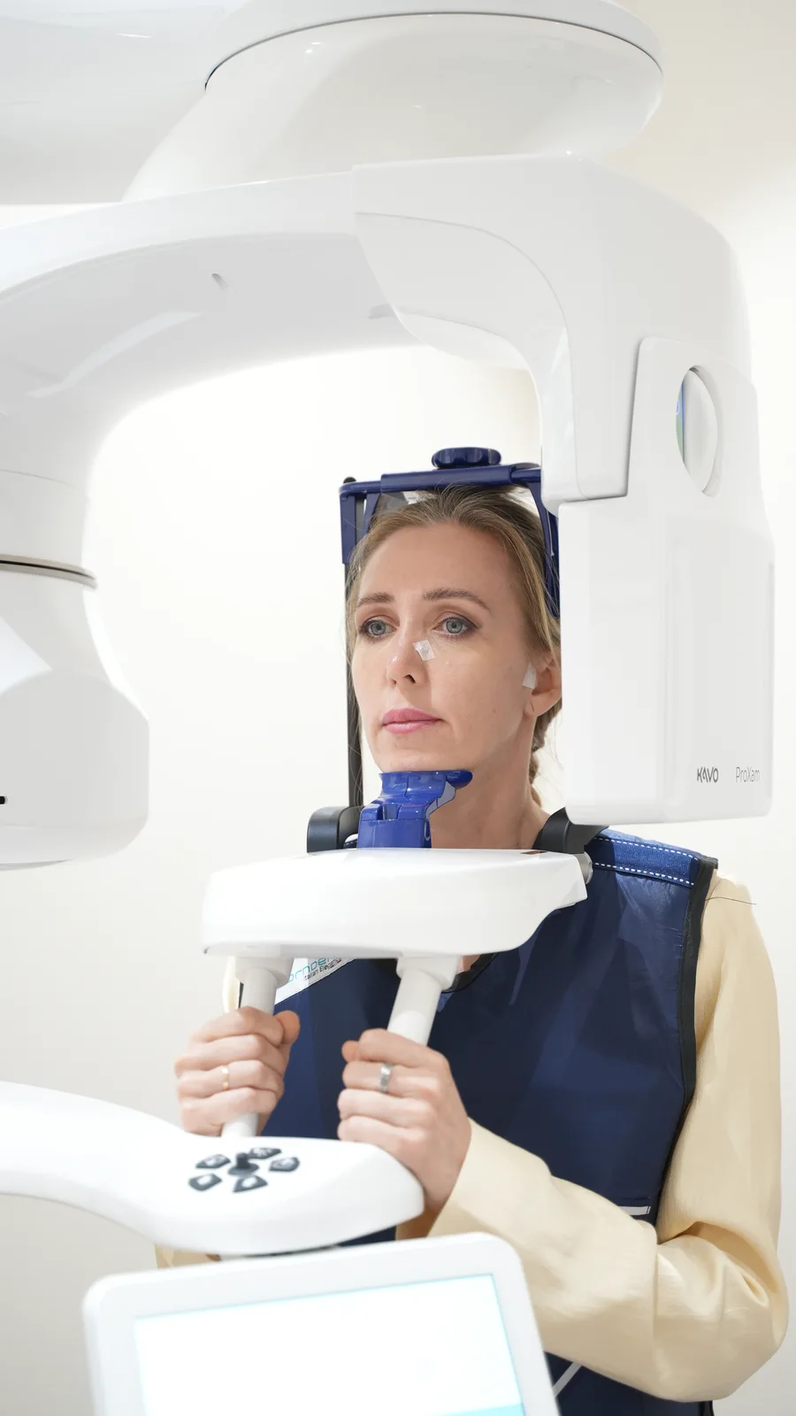 A patient positioned in dental imaging equipment